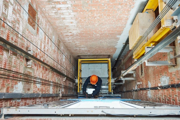Professional Technician Checking Elevator in a Building