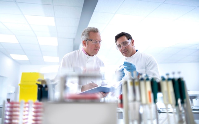 Scientists Discussing Test Results in Laboratory