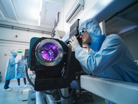 Scientists in Protective Clothing  in Laboratory Using Laser Equipment
