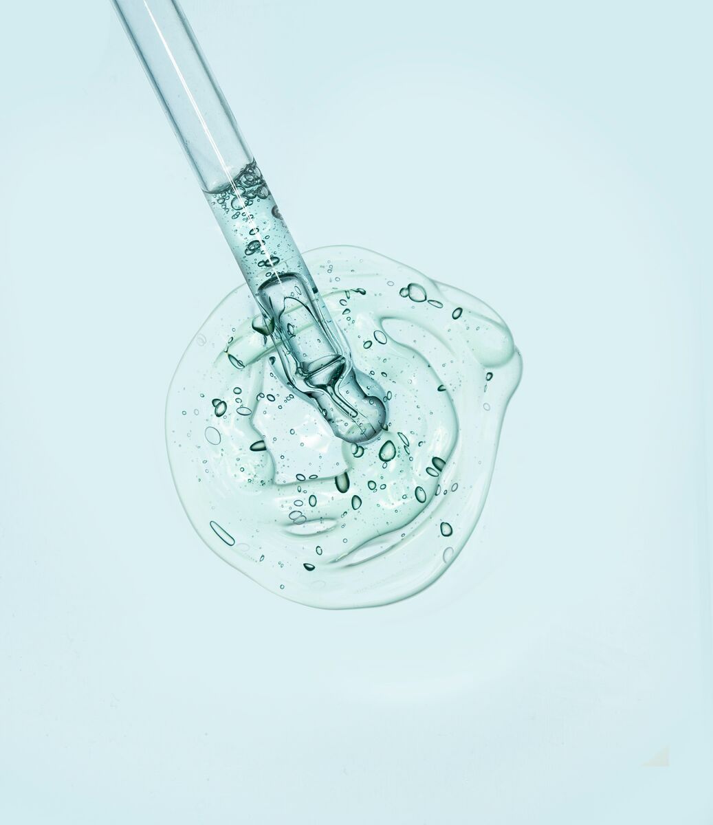 Serum Being Analysed wit a Microscope