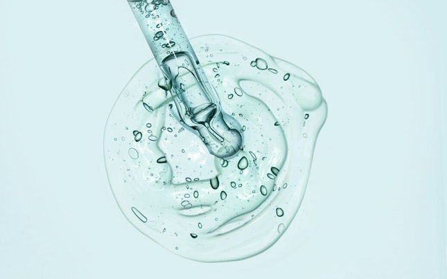 Serum Being Analysed wit a Microscope