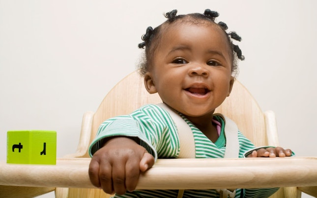 Baby Girl Strapped in a High Chair