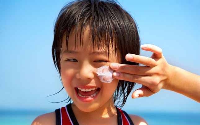 Sun Lotion Applied to boys Face