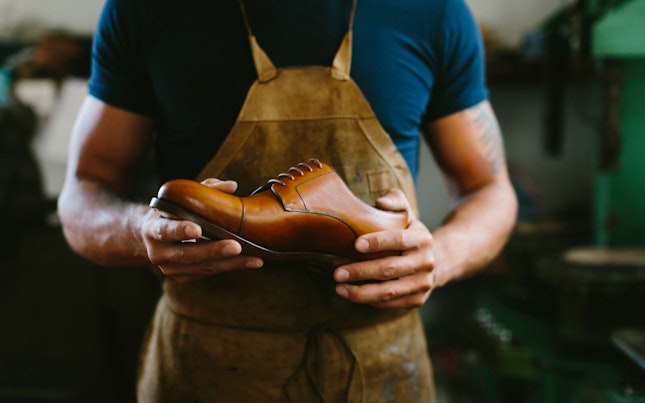 Shoemaker Holding Leather Shoe