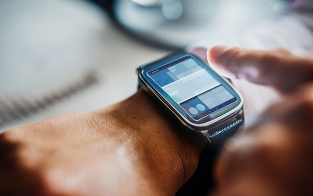 Man Holding External Battery and Smartphone