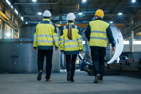 Three Engineers Walking Through Heavy Industry Manufacturing Factory