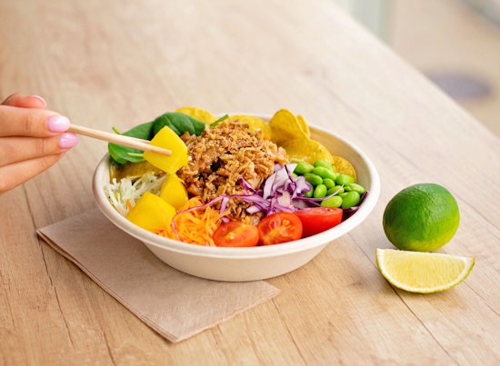 Man holding black grapes