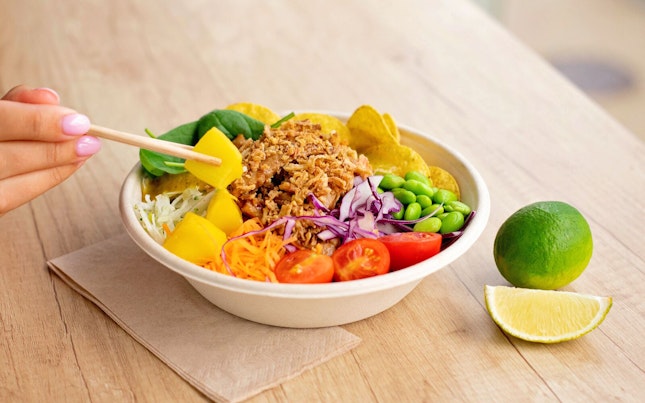 Man holding black grapes