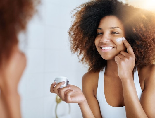 Woman Applying Moisturizer