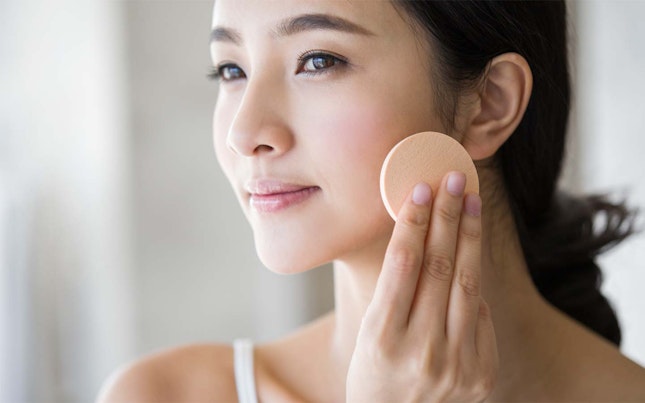 Woman applying powder