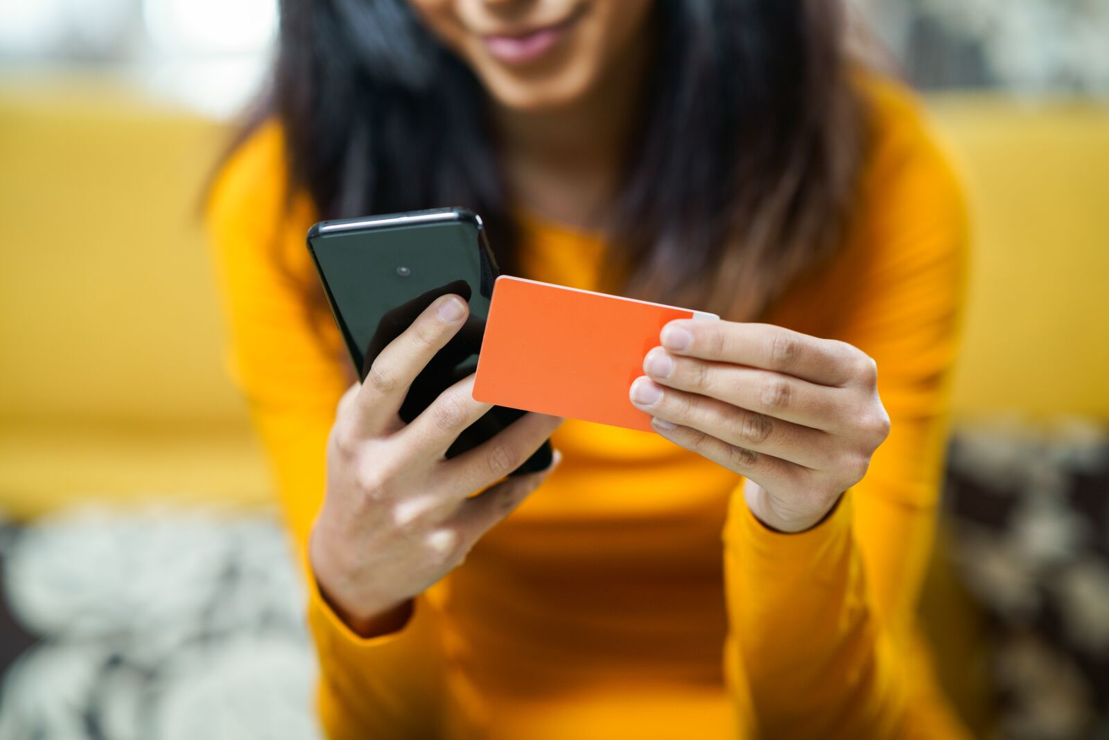 Woman using card in paying for her online shopping