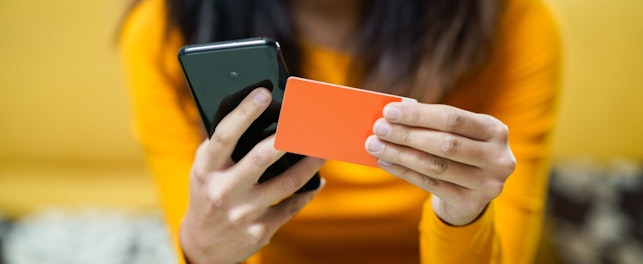 Woman using card in paying for her online shopping