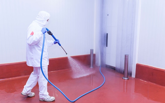 Worker Cleaning  Floor in Food Plant