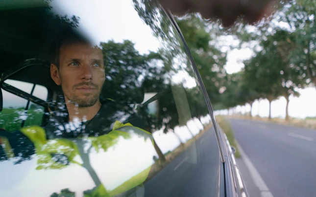 Worker Driving his Car in Country Side