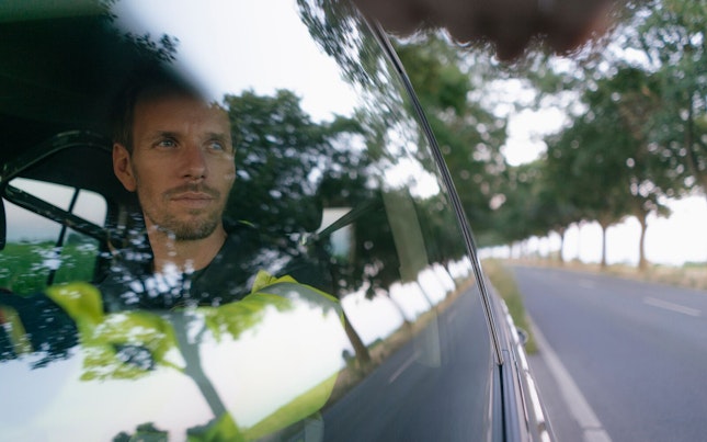Worker Driving his Car in Country Side