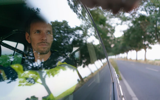 Worker Driving his Car in Country Side