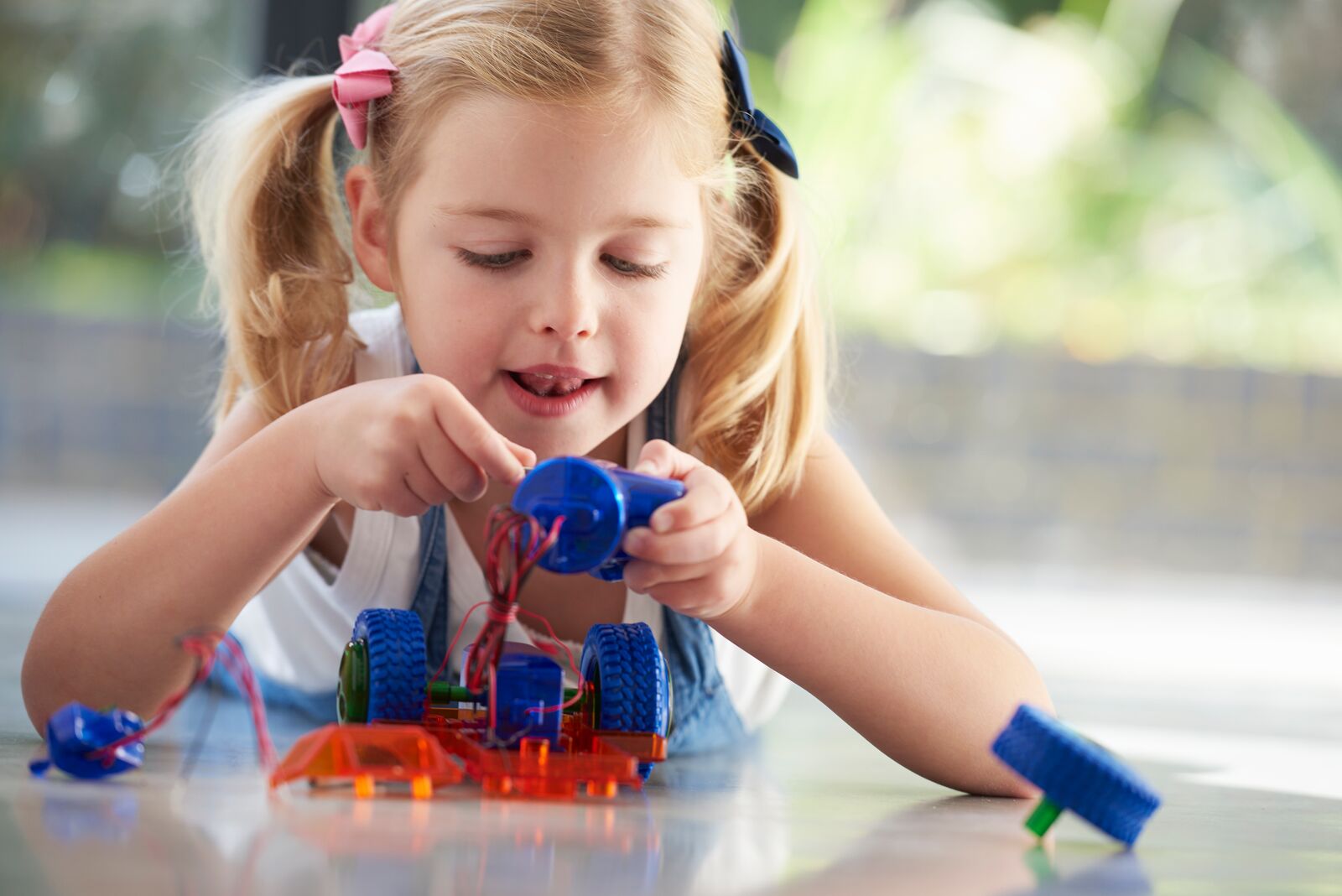 Young Girl Assembling a Robot